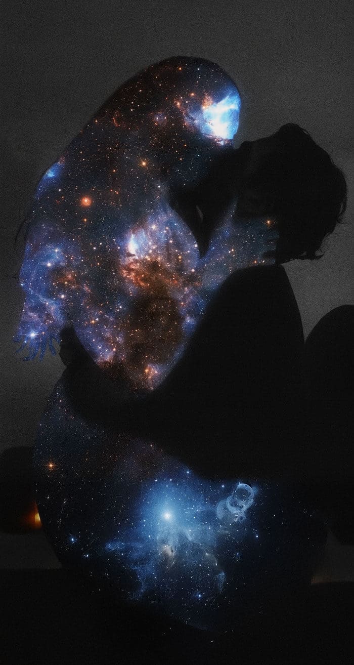 Two lovers kissing silhouettes of a galaxy